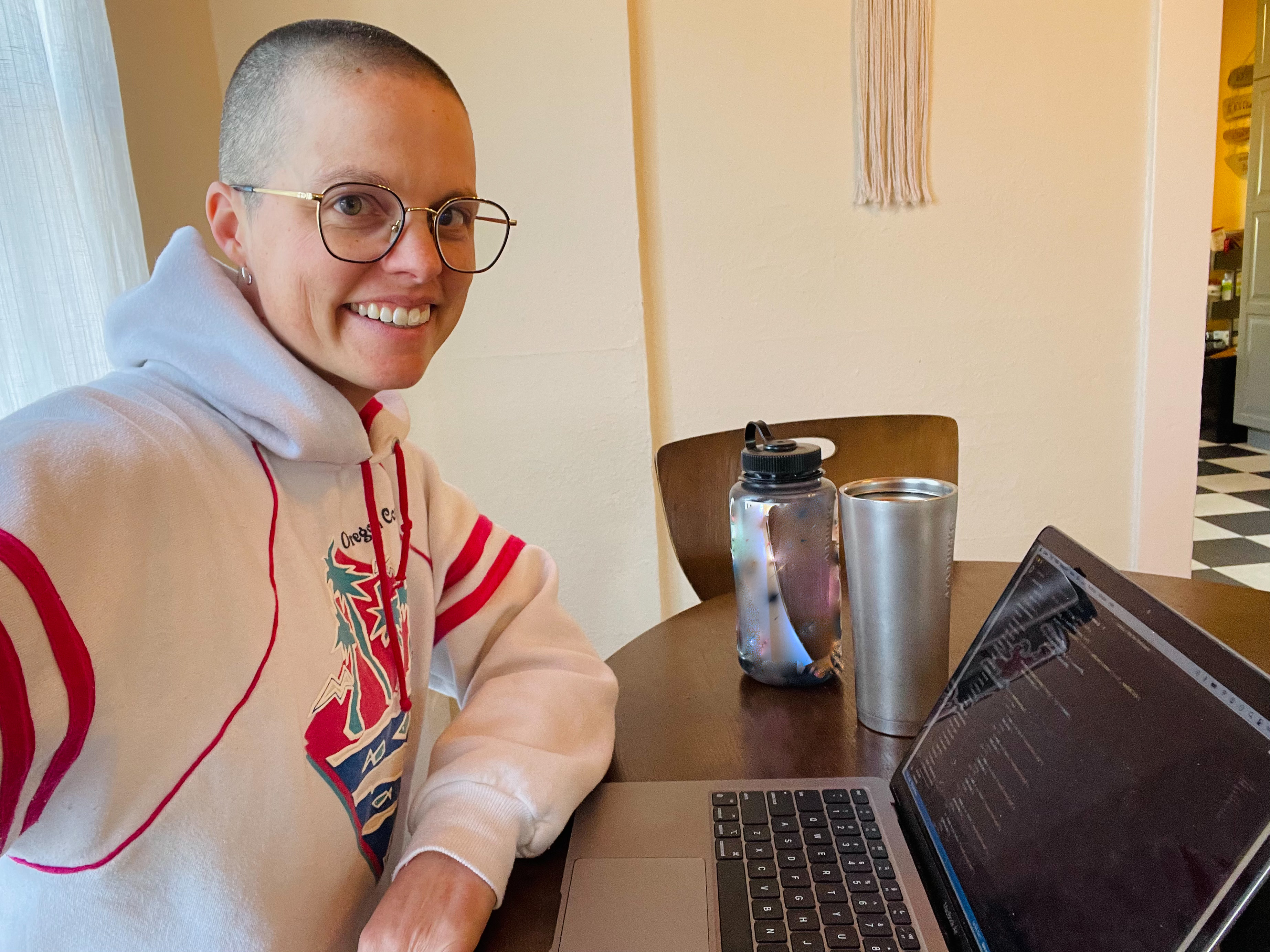 Photo of KaDee sitting at a computer