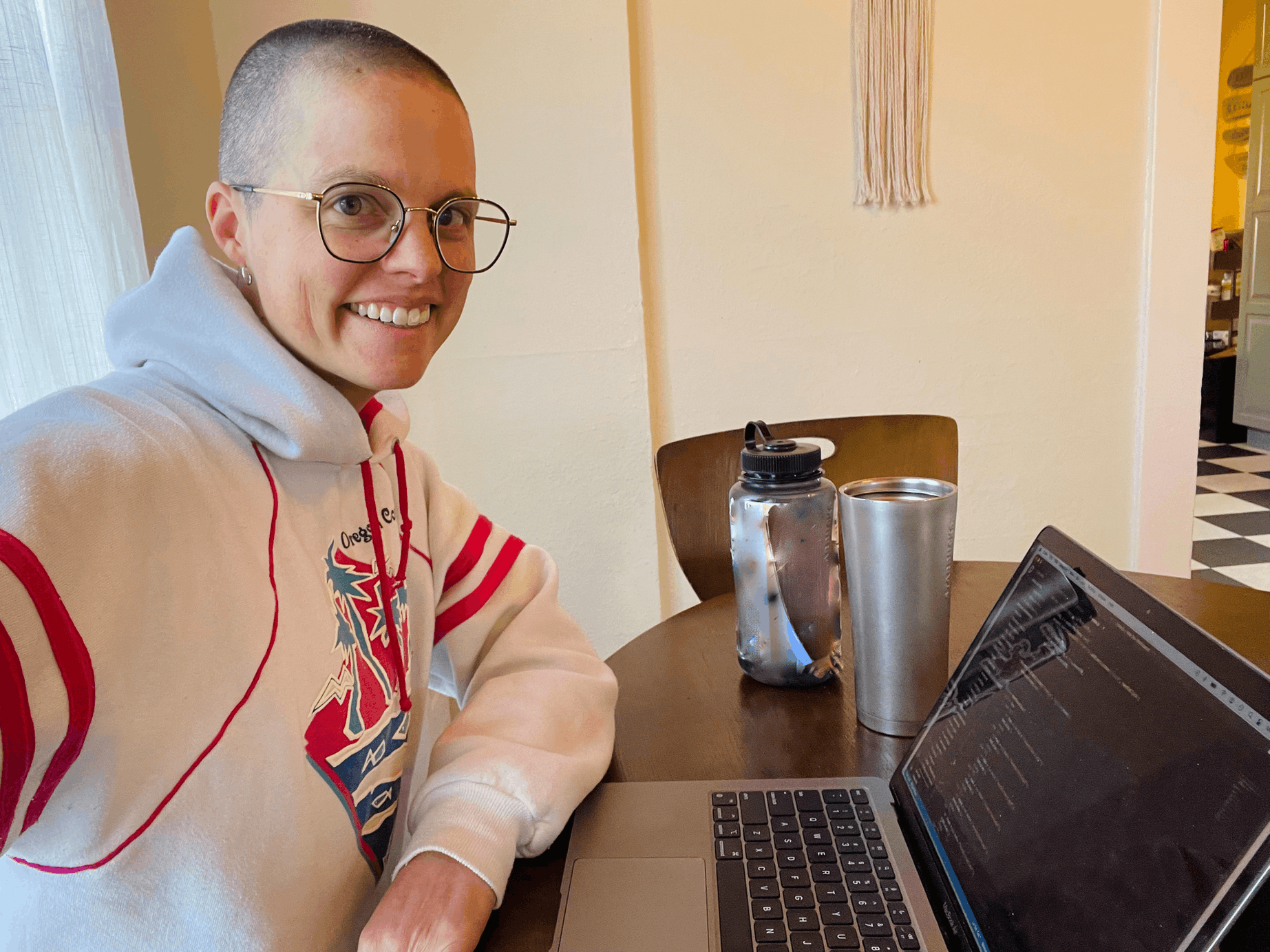 Photo of KaDee sitting at a computer